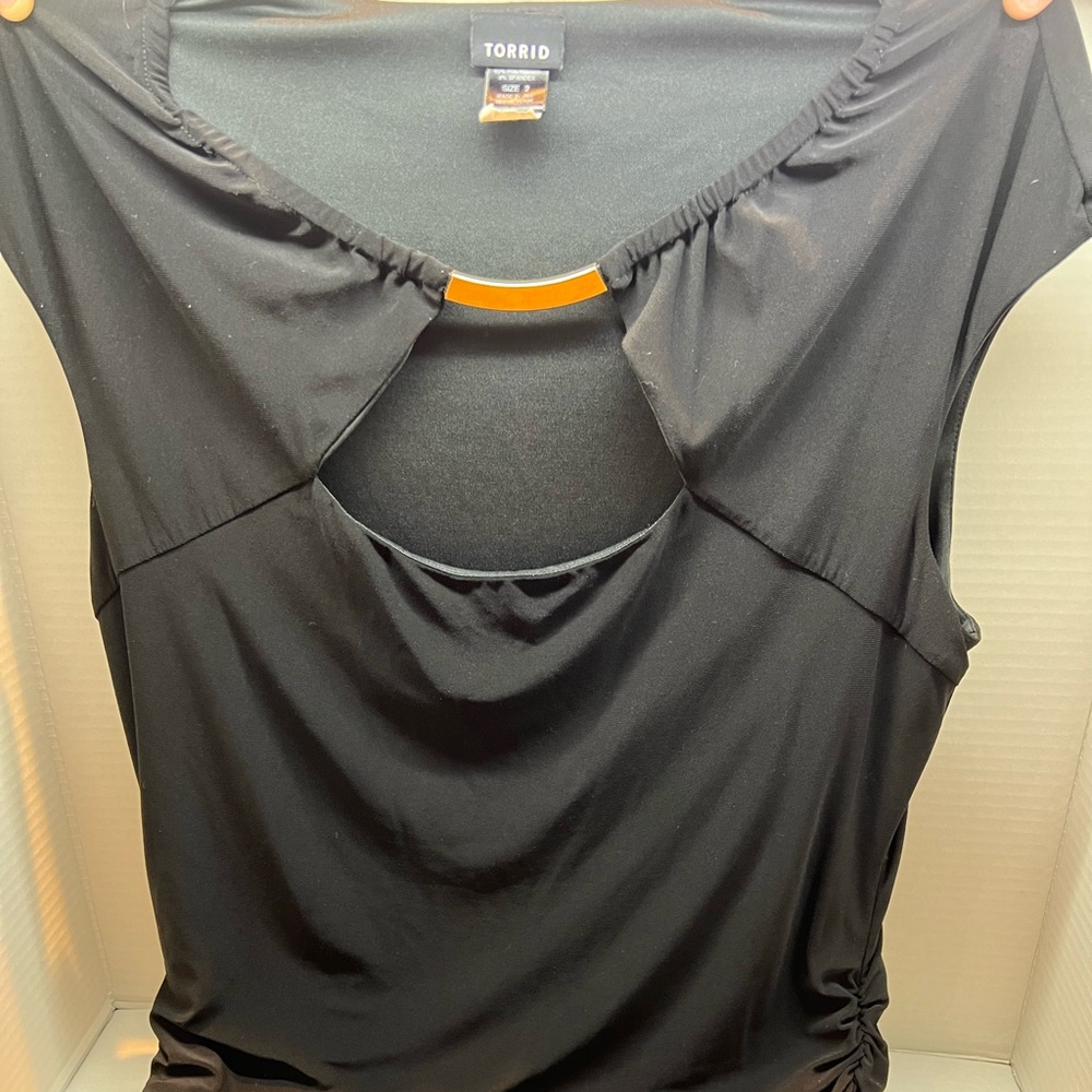 Black no sleeve dress shirt with gold loop on the neck